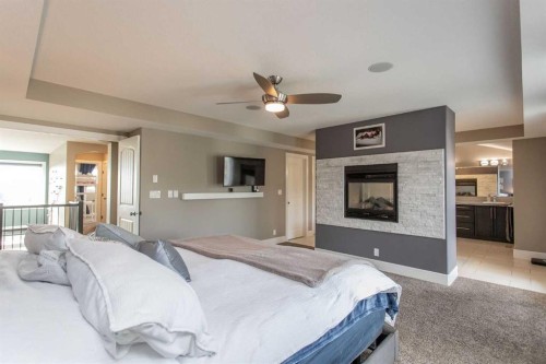 30 Parkridge Crescent, Blackfalds, AB - Indoor Photo Showing Bedroom With Fireplace