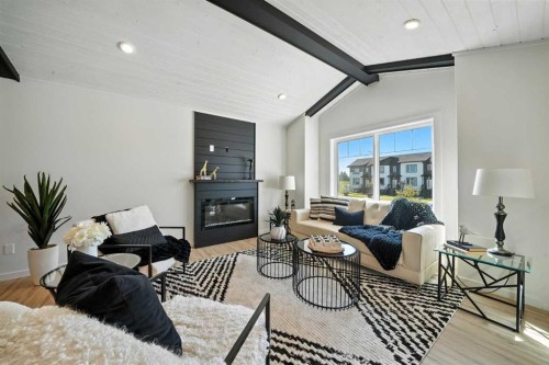 62 Metcalf Way, Lacombe, AB - Indoor Photo Showing Living Room With Fireplace