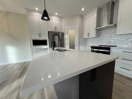 38 Tagish Avenue, Red Deer, AB - Indoor Photo Showing Kitchen With Double Sink With Upgraded Kitchen