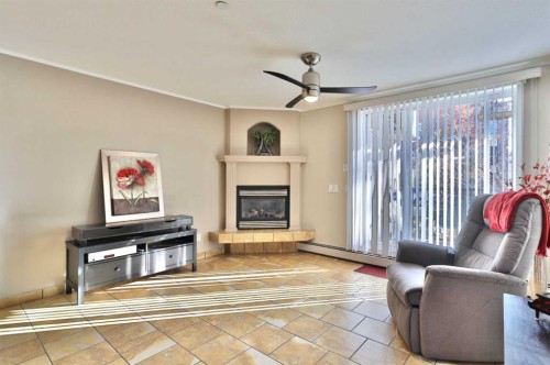 105-4834 52A Street, Camrose, AB - Indoor Photo Showing Living Room With Fireplace