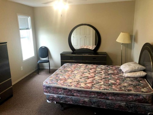 7017 Deer Street, Lacombe, AB - Indoor Photo Showing Bedroom