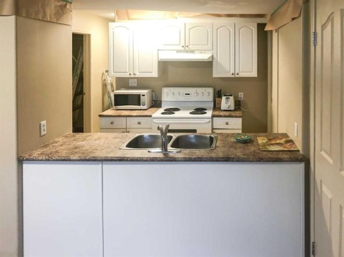 7017 Deer Street, Lacombe, AB - Indoor Photo Showing Kitchen With Double Sink