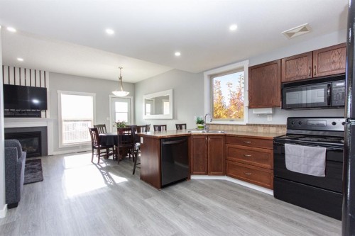 347 Addington Drive, Red Deer, AB - Indoor Photo Showing Kitchen With Fireplace With Double Sink