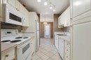 208-5135 Lakeshore Drive, Sylvan Lake, AB  - Indoor Photo Showing Kitchen With Double Sink 