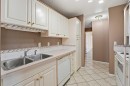 208-5135 Lakeshore Drive, Sylvan Lake, AB  - Indoor Photo Showing Kitchen With Double Sink 