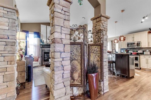 3 Legacy Cove, Sylvan Lake, AB - Indoor Photo Showing Kitchen With Fireplace