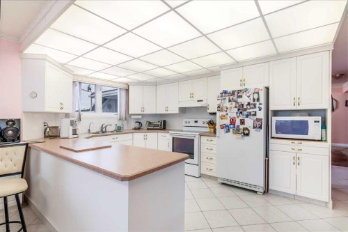 3 Rustic Road, Norglenwold, AB - Indoor Photo Showing Kitchen With Double Sink
