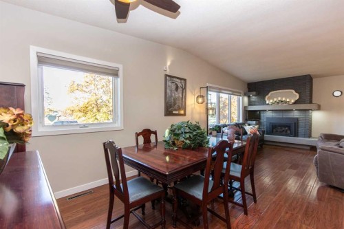 4413 Embury Crescent, Red Deer, AB - Indoor Photo Showing Dining Room With Fireplace