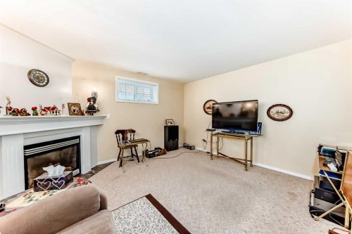 4514 54A Ave Cres, Innisfail, AB - Indoor Photo Showing Living Room With Fireplace