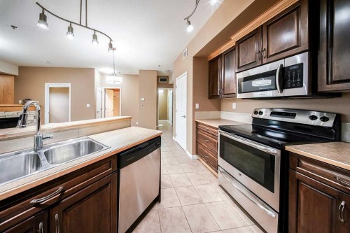 207-5040 53 Street, Sylvan Lake, AB - Indoor Photo Showing Kitchen With Double Sink