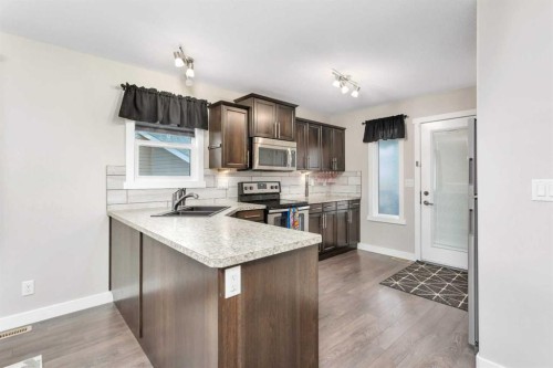 23 Hampton Crescent, Sylvan Lake, AB - Indoor Photo Showing Kitchen With Double Sink