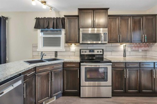 23 Hampton Crescent, Sylvan Lake, AB - Indoor Photo Showing Kitchen With Double Sink With Upgraded Kitchen