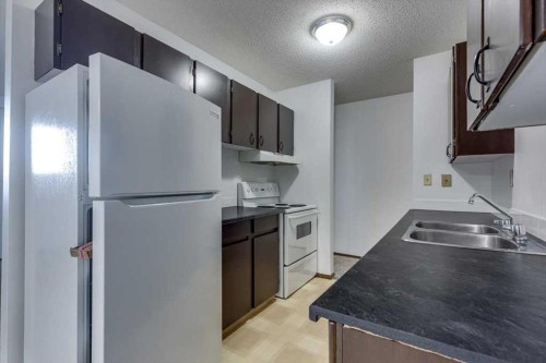 5418 And 5422 48 Avenue, Olds, AB - Indoor Photo Showing Kitchen With Double Sink