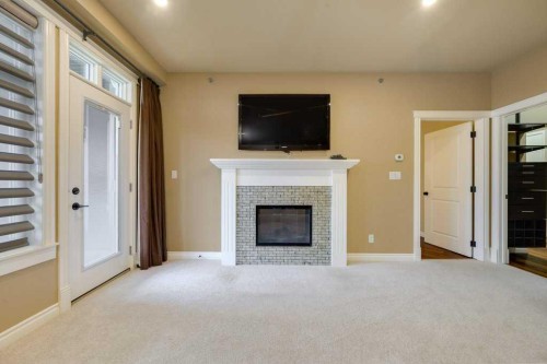 404-5213 61 Street, Red Deer, AB - Indoor Photo Showing Other Room With Fireplace