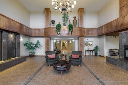 404-5213 61 Street, Red Deer, AB - Indoor Photo Showing Other Room With Fireplace