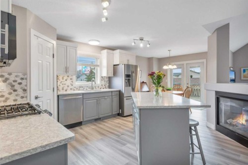 68 Falcon Crescent, Sylvan Lake, AB - Indoor Photo Showing Kitchen With Fireplace With Double Sink