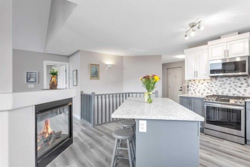68 Falcon Crescent, Sylvan Lake, AB - Indoor Photo Showing Kitchen With Fireplace With Upgraded Kitchen