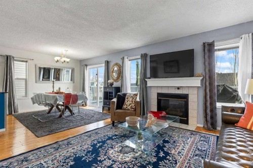 60 Bridlecreek Terrace Sw, Calgary, AB - Indoor Photo Showing Living Room With Fireplace