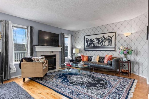 60 Bridlecreek Terrace Sw, Calgary, AB - Indoor Photo Showing Living Room With Fireplace