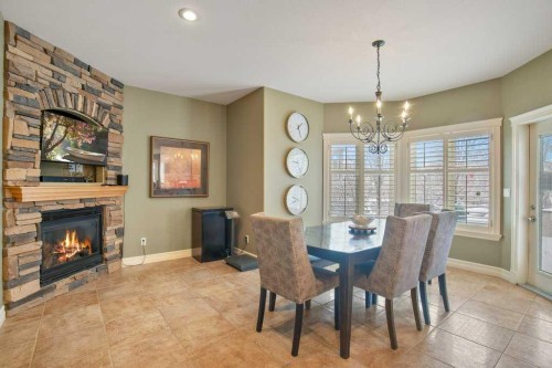 10 Fieldstone Way, Sylvan Lake, AB - Indoor Photo Showing Dining Room With Fireplace