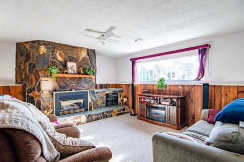 84 Pearson Crescent, Red Deer, AB - Indoor Photo Showing Living Room With Fireplace