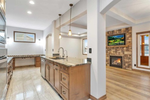 100 Van Slyke Way, Red Deer, AB - Indoor Photo Showing Kitchen With Fireplace
