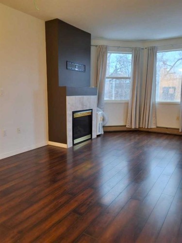 202-5211 39 Street, Red Deer, AB - Indoor Photo Showing Living Room With Fireplace