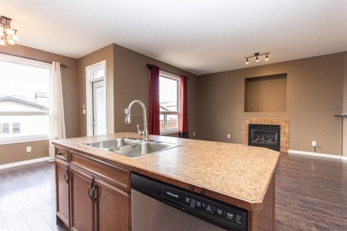 152 Oswald Close, Red Deer, AB - Indoor Photo Showing Kitchen With Fireplace With Double Sink