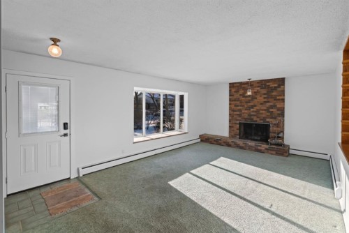 5714 48B Avenue, Camrose, AB - Indoor Photo Showing Living Room With Fireplace