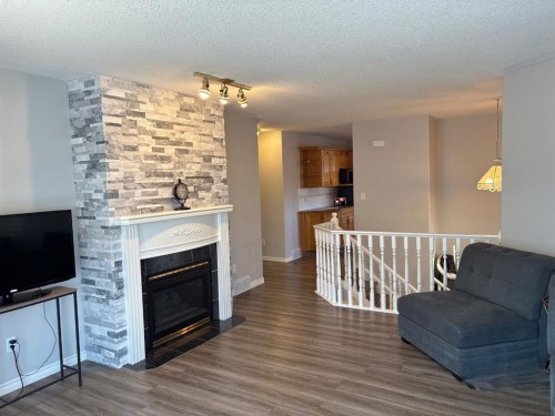 14 Lawrence Crescent, Red Deer, AB - Indoor Photo Showing Living Room With Fireplace