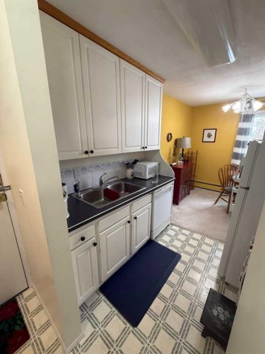 201-5519 Kerry Wood Drive, Red Deer, AB - Indoor Photo Showing Kitchen With Double Sink