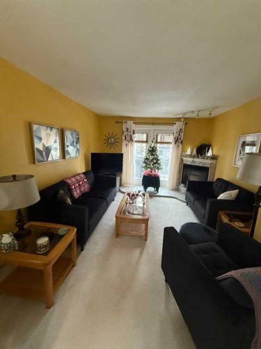 201-5519 Kerry Wood Drive, Red Deer, AB - Indoor Photo Showing Living Room With Fireplace