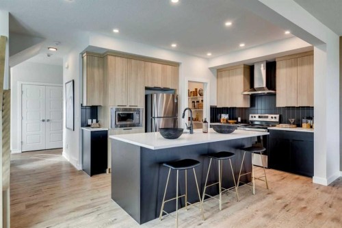 12 Aster Link, Okotoks, AB - Indoor Photo Showing Kitchen With Stainless Steel Kitchen With Upgraded Kitchen