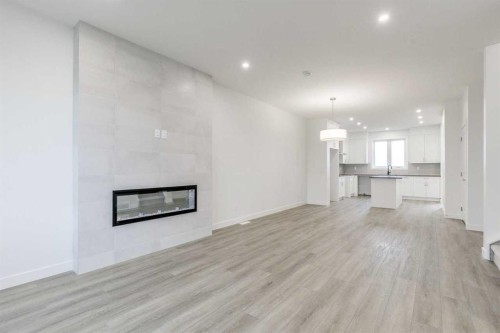 221 Bridgeport Gate Sw, Chestermere, AB - Indoor Photo Showing Living Room With Fireplace