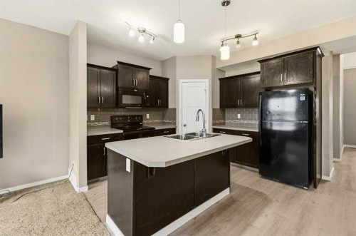 1-5301 Windward Place, Sylvan Lake, AB - Indoor Photo Showing Kitchen With Double Sink