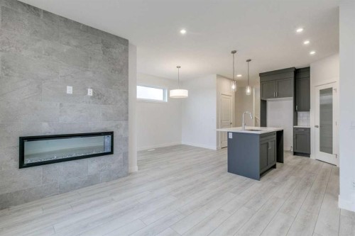 205 Bridgeport Gate, Chestermere, AB - Indoor Photo Showing Other Room With Fireplace