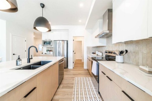 136 Versant Point Sw, Calgary, AB - Indoor Photo Showing Kitchen With Double Sink With Upgraded Kitchen