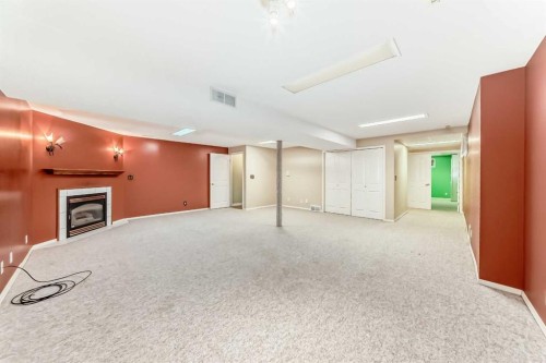 135 Kemp Avenue, Red Deer, AB - Indoor Photo Showing Other Room With Fireplace