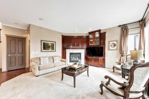 40 Cougar Ridge Heights Sw, Calgary, AB - Indoor Photo Showing Living Room With Fireplace