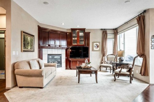 40 Cougar Ridge Heights Sw, Calgary, AB - Indoor Photo Showing Living Room With Fireplace