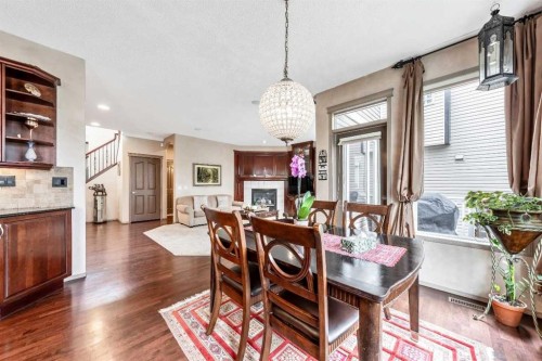40 Cougar Ridge Heights Sw, Calgary, AB - Indoor Photo Showing Dining Room With Fireplace