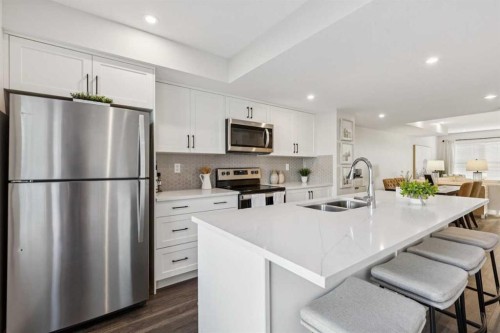 107-135 Mahogany Parade Se, Calgary, AB - Indoor Photo Showing Kitchen With Stainless Steel Kitchen With Double Sink With Upgraded Kitchen