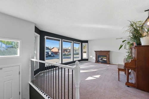 56 Marion Crescent, Red Deer, AB - Indoor Photo Showing Other Room With Fireplace