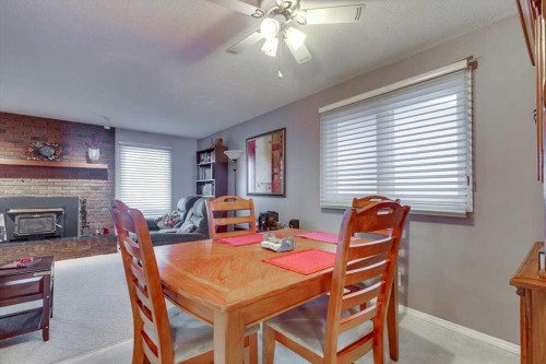 57 Mcdougall Crescent, Red Deer, AB - Indoor Photo Showing Dining Room With Fireplace