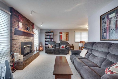 57 Mcdougall Crescent, Red Deer, AB - Indoor Photo Showing Living Room With Fireplace