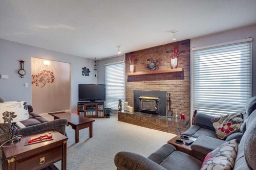 57 Mcdougall Crescent, Red Deer, AB - Indoor Photo Showing Living Room With Fireplace