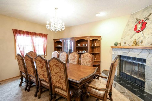 10-27501 Township Road 374, Rural Red Deer County, AB - Indoor Photo Showing Dining Room With Fireplace