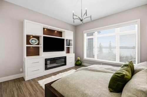 32 Sawyer Close, Red Deer, AB - Indoor Photo Showing Bedroom With Fireplace
