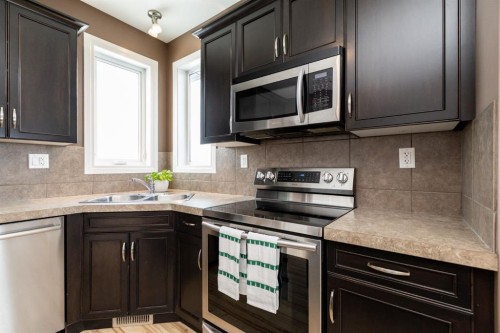 6321 58 Avenue, Innisfail, AB - Indoor Photo Showing Kitchen With Stainless Steel Kitchen With Double Sink