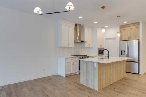 1402 Bayview Crescent Sw, Airdrie, AB - Indoor Photo Showing Kitchen With Upgraded Kitchen